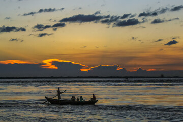Traditional fishing boat on the river. Fisherman in a small boat on the river.