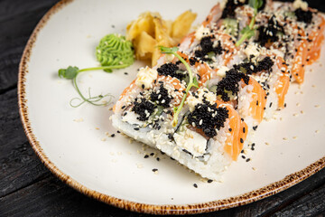 sushi roll with wasabi and sesame seeds on the plate. delicious food, close-up
