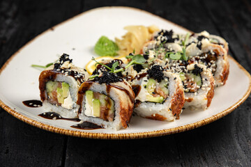 sushi roll with wasabi and sesame seeds on the plate. delicious food, close-up