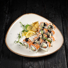 sushi roll with wasabi and sesame seeds on the plate. delicious food, close-up