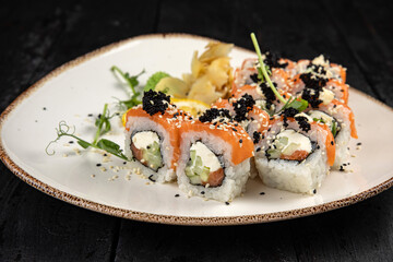 sushi roll with wasabi and sesame seeds on the plate. delicious food, close-up