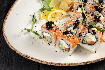 sushi roll with wasabi and sesame seeds on the plate. delicious food, close-up