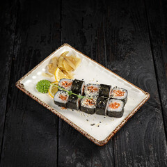 sushi roll with wasabi and sesame seeds on the plate. delicious food, close-up