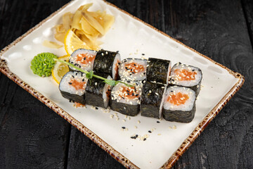 sushi roll with wasabi and sesame seeds on the plate. delicious food, close-up