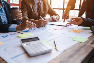 Group of asian business advisor discussing financial reporting situation together in boardroom.