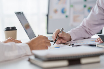 Business people discussing and meeting in board rood with paper chart on desk.