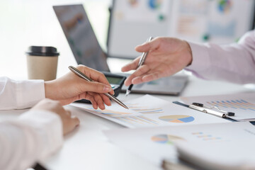 Business people discussing and meeting in board rood with paper chart on desk.