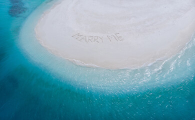 Marry Me Word Written On Sunny Summer Beach Sand. Uninhabited exotic island