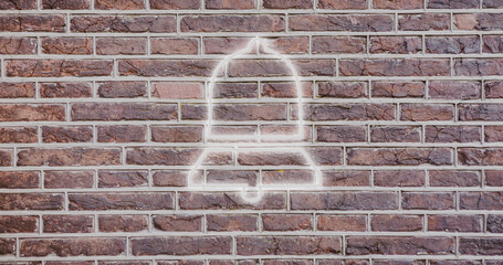 Composite of digital illuminated notification bell icon against brick wall, copy space