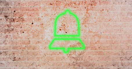 Composite of digital green notification bell icon against dirty brick wall, copy space