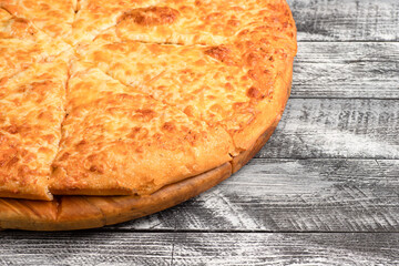 Pizza, homemade large size pizza on a wooden white background