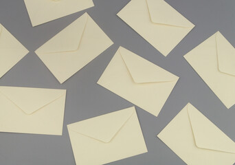 Many mail envelops on gray background.