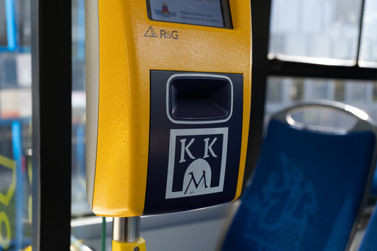 MPK Krak&oacute;w validation machine, with KKM Krakowska Karta Miejska (Cracow City Card) logo sign. Electronic validator for public transport bus or tram tickets on October 8, 2022 in Krakow, Poland.