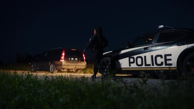 Highway Traffic Patrol Car Pull Over: Two Police Officers Approach, Order Driver to Step out of the Vehicle and Start Searching Suspect. Cops Arresting Criminal. Artistic Cinematic Slow Motion Shot