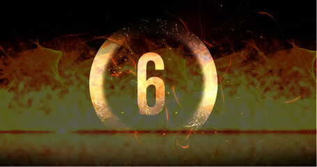 Image of ring and glowing number six in dramatic countdown over flaming fire background