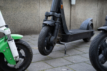 Dockless electric scooters to rent via app, parked on a city street. Scooter sharing system, renting modern vehicle with mobile phone. © Longfin Media