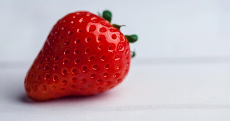 Close-up of fresh red strawberry isolated over white background, copy space