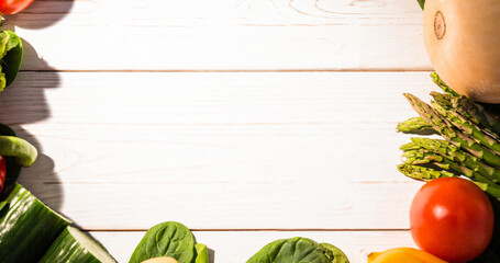 Cropped image of fresh raw vegetables on wooden table, copy space