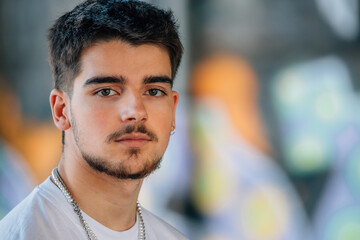 portrait of millennial young man with beard looking at camera