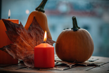 pumpkins and candles on the wooden table. halloween party concept