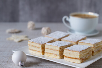 A square slices of festive Snow White  Christmas  cake with vanilla cream filling