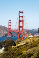 Famous Golden Gate bridge in San Francisco with a clear blue sky and wavy sea