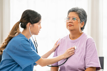 Healthcare and nursing service, Doctor using stethoscope to check up a Asian senior woman and talking about treatment