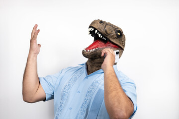 euphoric man with T Rex head talking on the phone. Absurd and surreal funny concept