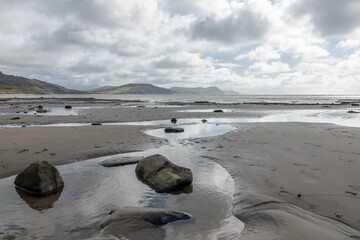 rock pools on a beautiful deserted sandy beach in Lyme Regis Dorset England Jurassic Coast