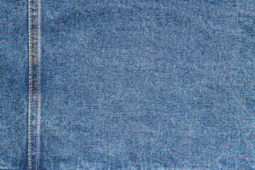 texture of blue jeans denim fabric with seam background	