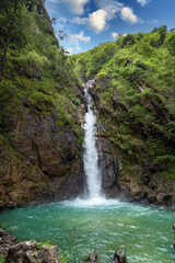 Fototapeta na wymiar Waterfall in the deep forest valley