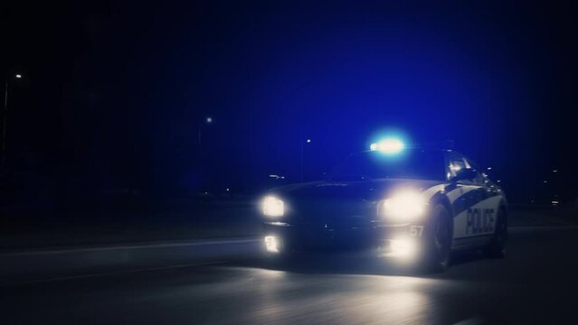 Traffic Patrol Car In Pursuit, Driving Fast with Sirens Blazing through the City Streets. Officers of the Law Chasing a Suspect. Cops in Squad Car React to Emergency Call. Cinematic Night Shot