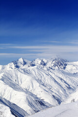 Sunny slopes of winter mountains