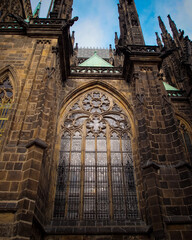 Fototapeta premium St. Vitus Cathedral. Beautiful view of the gothic cathedral, low angle view. Nice view of the stained glass windows.