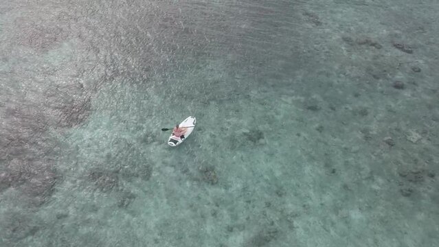 Aerial video footage of a kayak moving forward in the Maldives