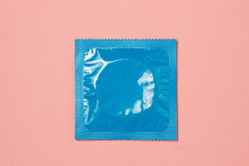 Condom on a pink background. contraceptive and protection. safe sex