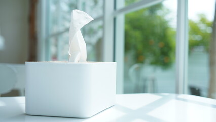 Tissue paper in napkin paper wooden white box on table. White sheet paper for cleaning face....