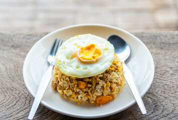 Fried egg served with fried rice for breakfast.