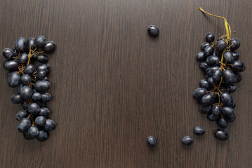 black grapes on a wooden brown table