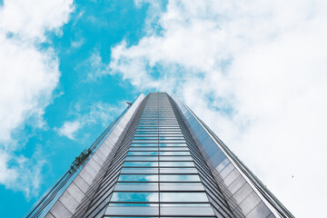 Fototapeta premium underside panoramic and perspective view to steel blue glass high rise building skyscrapers