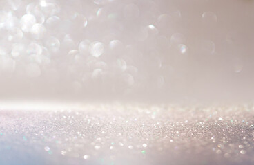 Beautiful festive background image with sparkles and bokeh in pastel pearl and silver colors....
