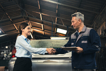 professional male technician mechanic man working to repair maintenance automobile at auto car garage service, talking with vehicle owner client about workshop job, automotive engine business shop