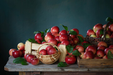 Fototapeta na wymiar red apples on old wooden table on background green wall