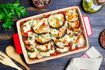 Baked eggplant with cheese mozzarella and tomatoes. Healthy eating. Italian food. Parmigiana di melanzane.