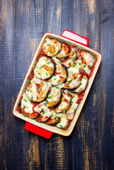 Baked eggplant with cheese mozzarella and tomatoes. Healthy eating. Italian food. Parmigiana di melanzane.