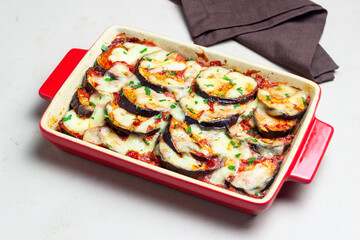 Baked eggplant with cheese mozzarella and tomatoes. Healthy eating. Italian food. Parmigiana di melanzane.