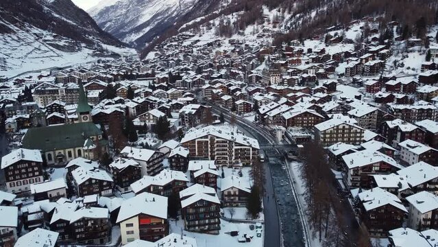 Zermatt, Switzerland: Aerial drone footage of the famous Zermatt traditional village in the Swiss alps in winter. 