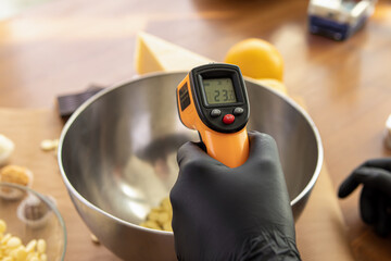 Contactless infrared confectionery thermometer. Professional pastry chef or chocolatier
