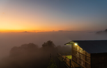 Hilltribe minority house's, homestay for tourist in the morning fog at sunset on the mountain in northern Thaland.