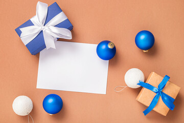 Gift boxes, Christmas tree decorations and greeting card for text on a brown background. Concept for New Years and Christmas Eve. Banner. Flat lay, top view